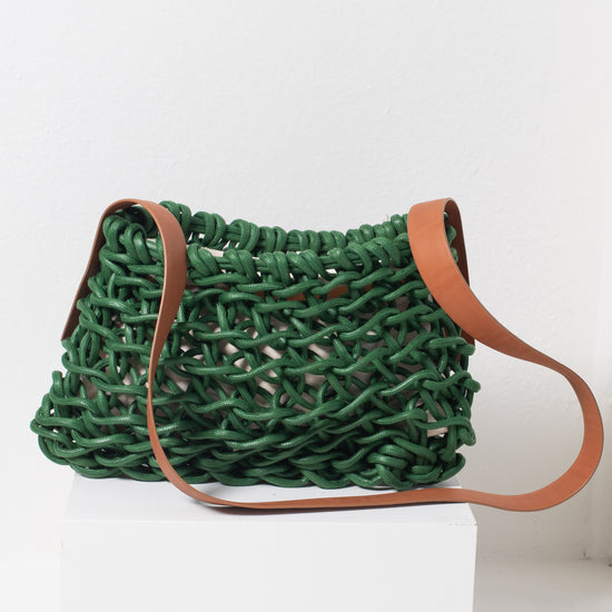 Italian handbag. Small cross body bag make of woven cotton rope with leather shoulder strap.  green in color