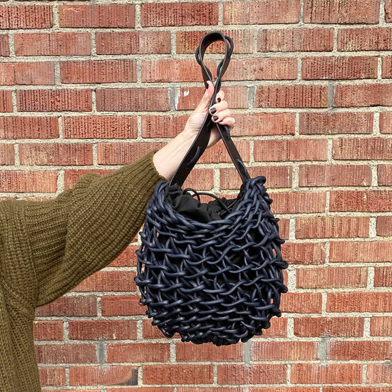Italian handbag. Small shoulder bag make of woven cotton rope with leather shoulder strap. navy blue color